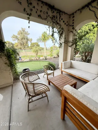 a view of a chairs and table in patio