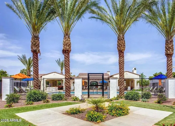 a front view of a house with a yard and fountain