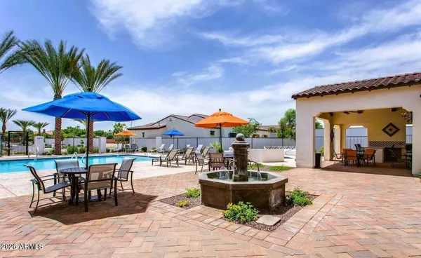 a view of a patio with a table and chairs under an umbrella