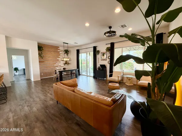 a living room with furniture and wooden floor