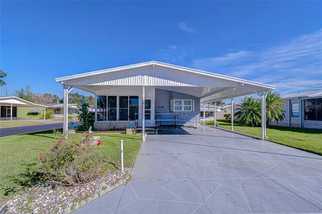 a view of a house with backyard porch and sitting area