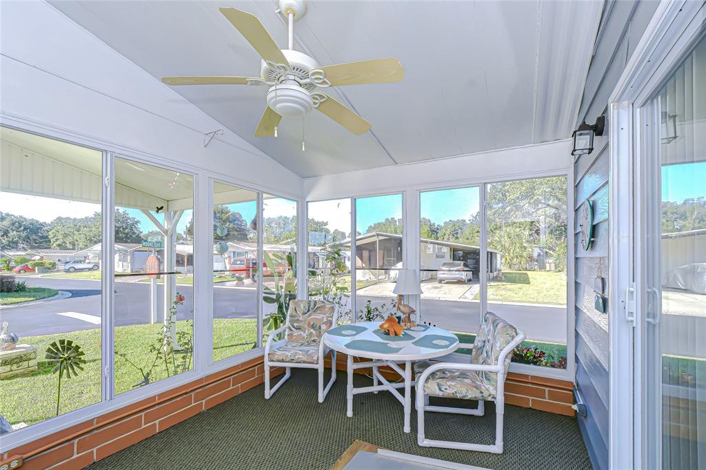 3210 Moonlight Street Wesley Chapel, FL 33543 - Photo 22 of 49 a dining room with furniture a rug and a floor to ceiling window