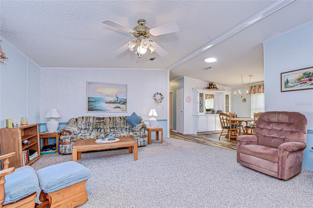 3210 Moonlight Street Wesley Chapel, FL 33543 - Photo 24 of 49 a bedroom with furniture and a chandelier