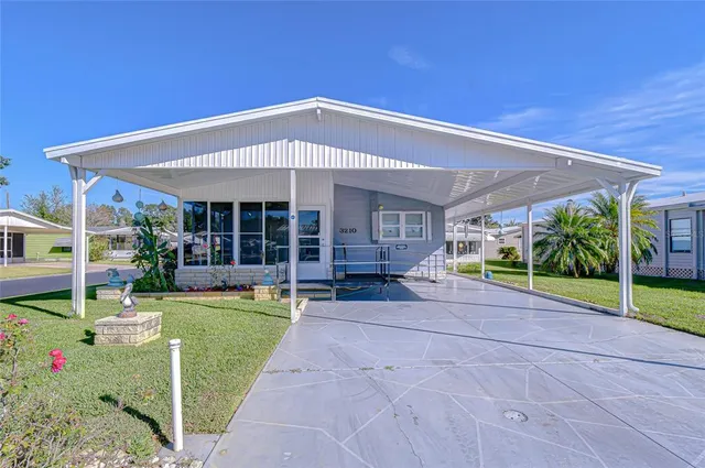 a view of a house with backyard and sitting area