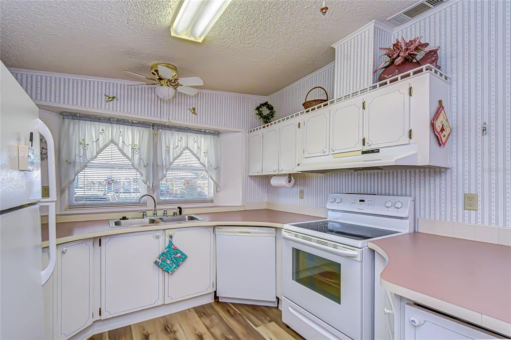 3210 Moonlight Street Wesley Chapel, FL 33543 - Photo 31 of 49 a kitchen with stainless steel appliances granite countertop a sink and cabinets