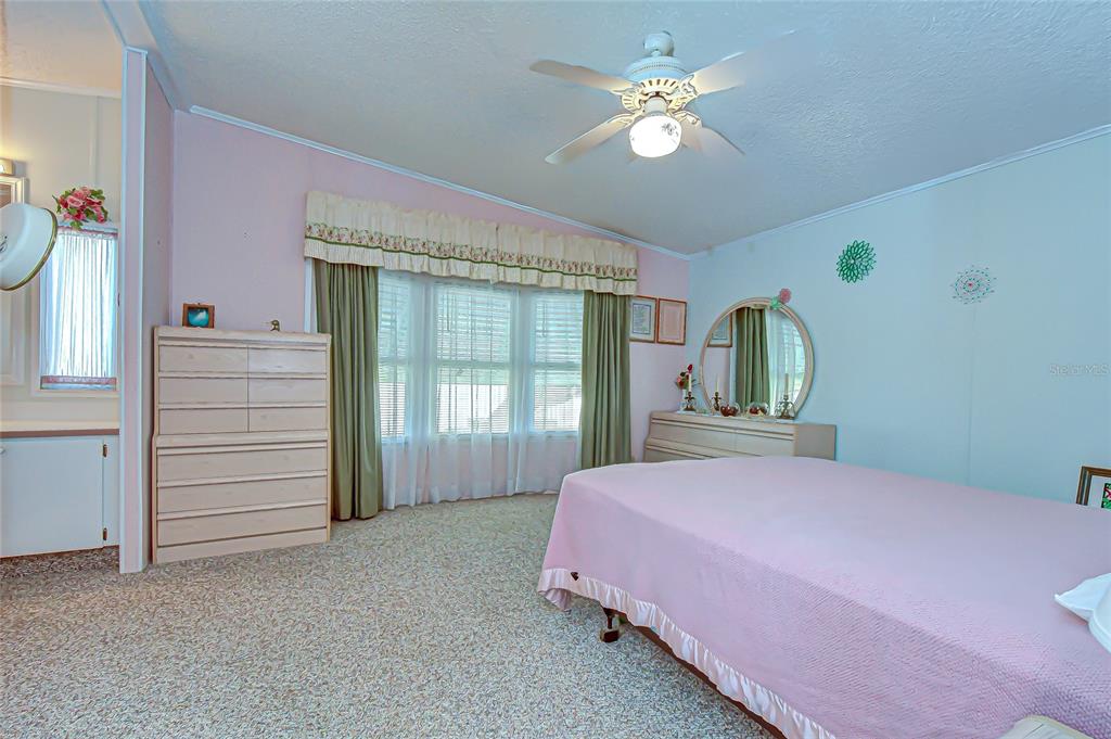 3210 Moonlight Street Wesley Chapel, FL 33543 - Photo 38 of 49 a bedroom with a bed chandelier and a window