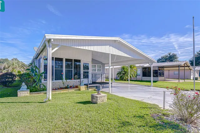 a view of a house with a yard and sitting area