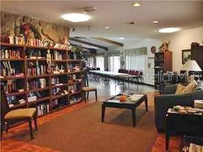 3210 Moonlight Street Wesley Chapel, FL 33543 - Photo 48 of 49 a living room with furniture a rug and a chandelier
