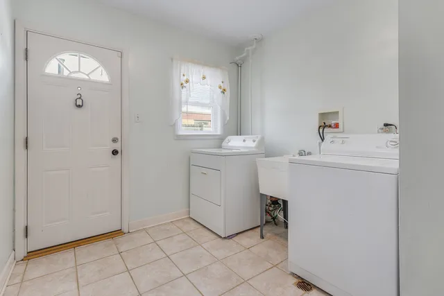 a utility room with cabinets washer and dryer