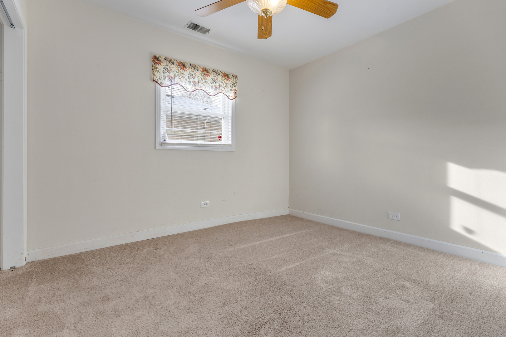 14305 Kostner Avenue Midlothian, IL 60445 - Photo 14 of 22 an empty room with windows and chandelier fan
