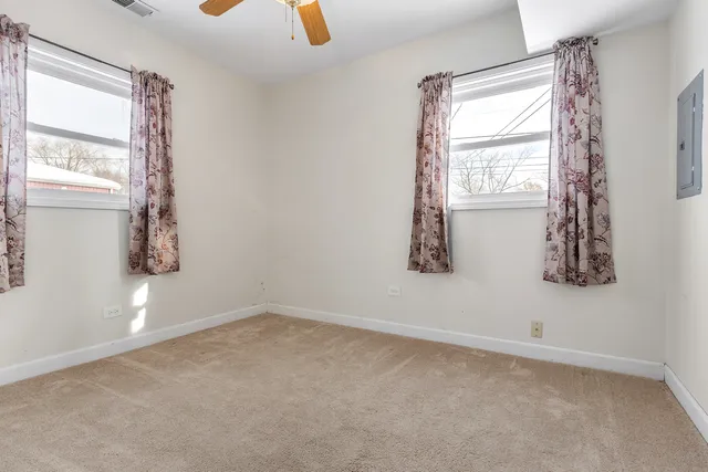 a view of a house with a wooden fence