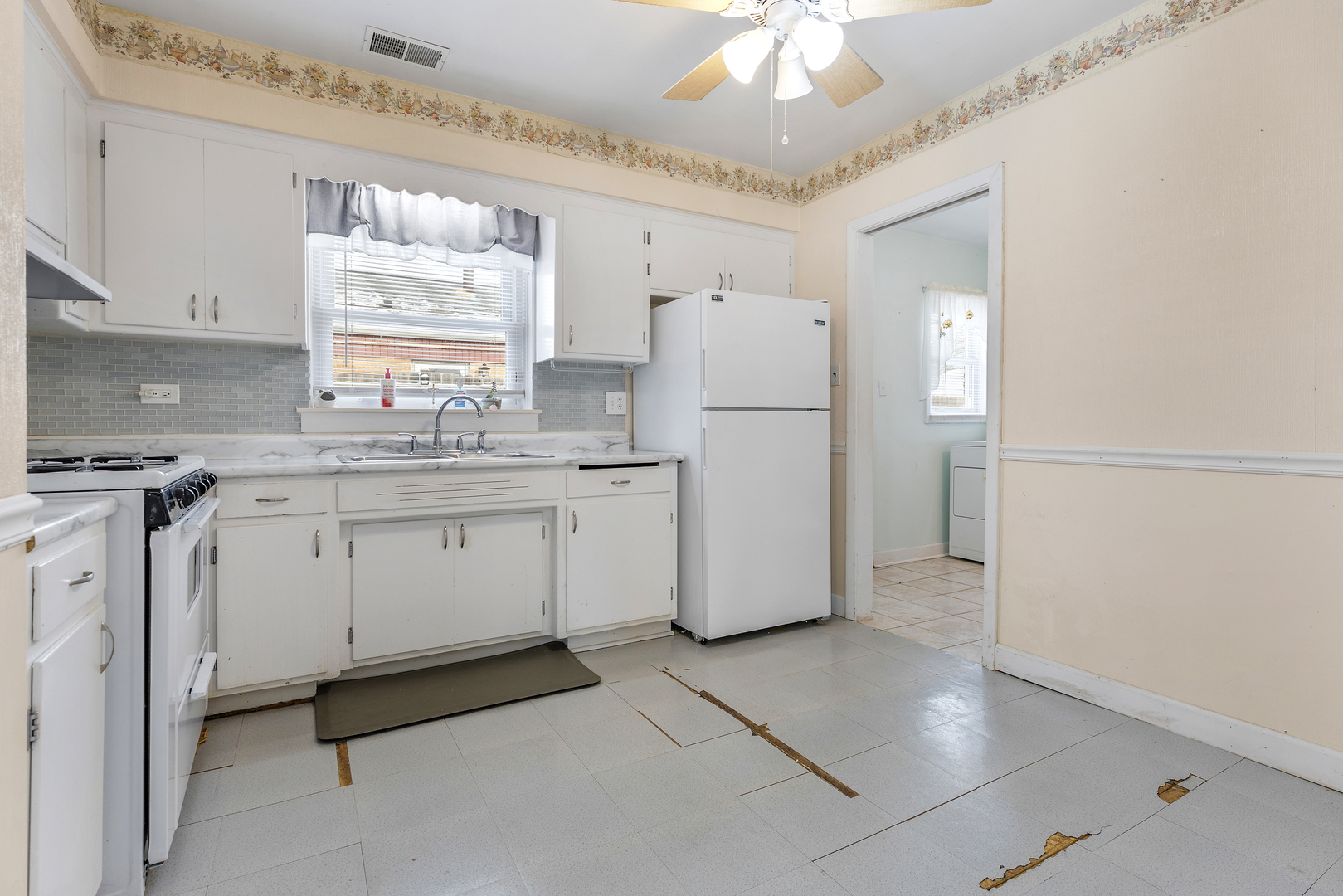 14305 Kostner Avenue Midlothian, IL 60445 - Photo 10 of 22 a kitchen with a refrigerator a sink dishwasher with a dining table and chairs