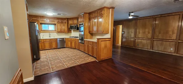 a kitchen with stainless steel appliances granite countertop a refrigerator and a sink