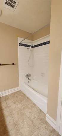 a bathroom with a granite countertop sink mirror and bathtub
