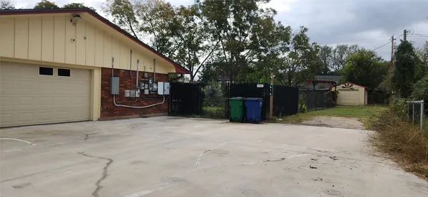 a backyard of a house with table and chairs
