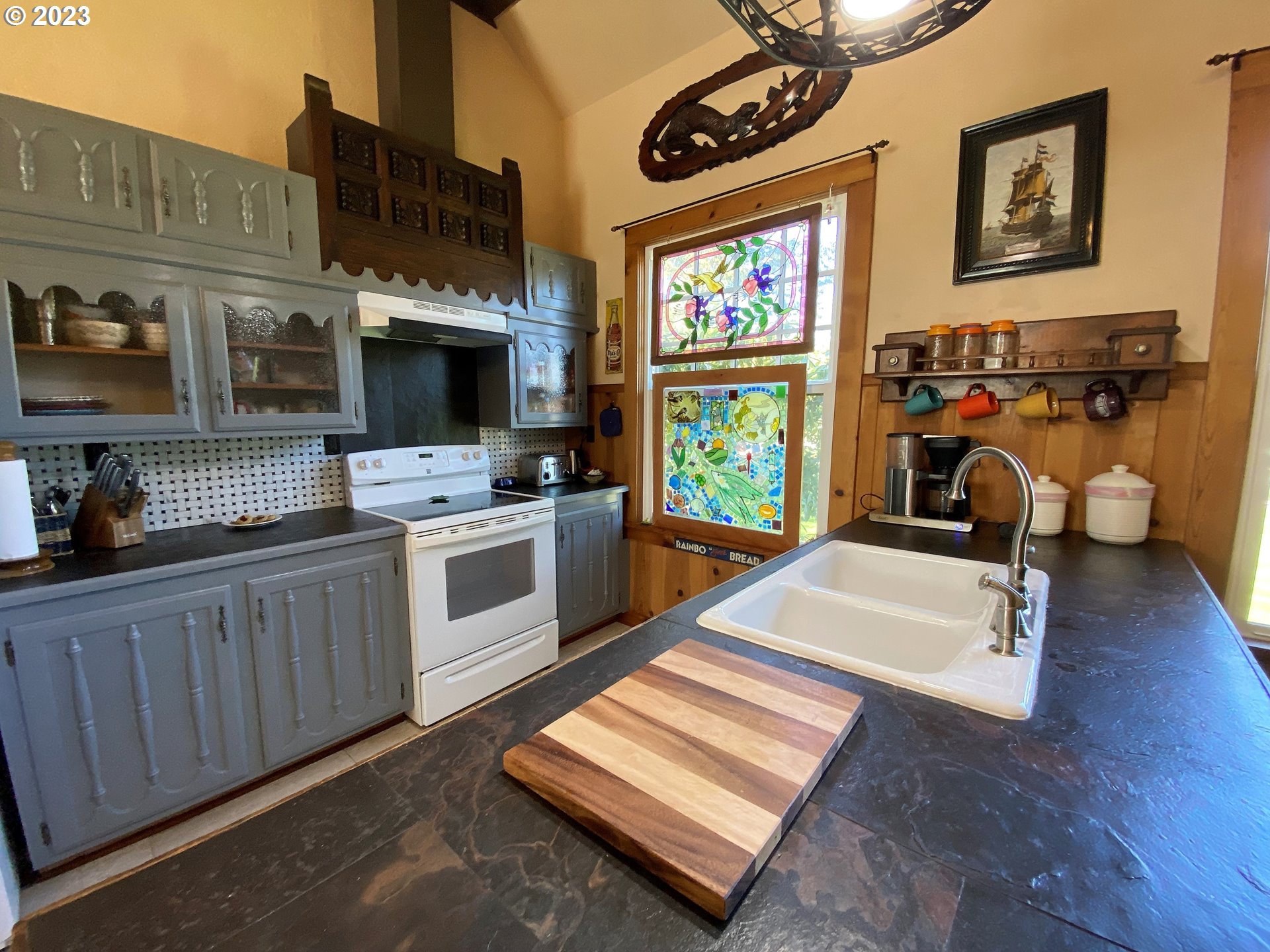 174 North 20th Street Reedsport, OR 97467 - Photo 19 of 43 a kitchen with furniture and a wooden floor