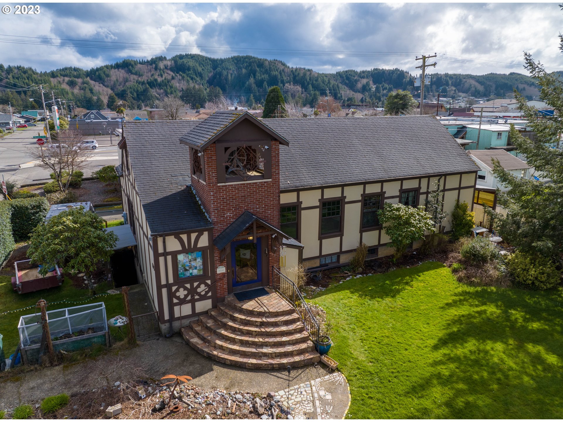 174 North 20th Street Reedsport, OR 97467 - Photo 2 of 43 a front view of a house with a yard garden and outdoor seating