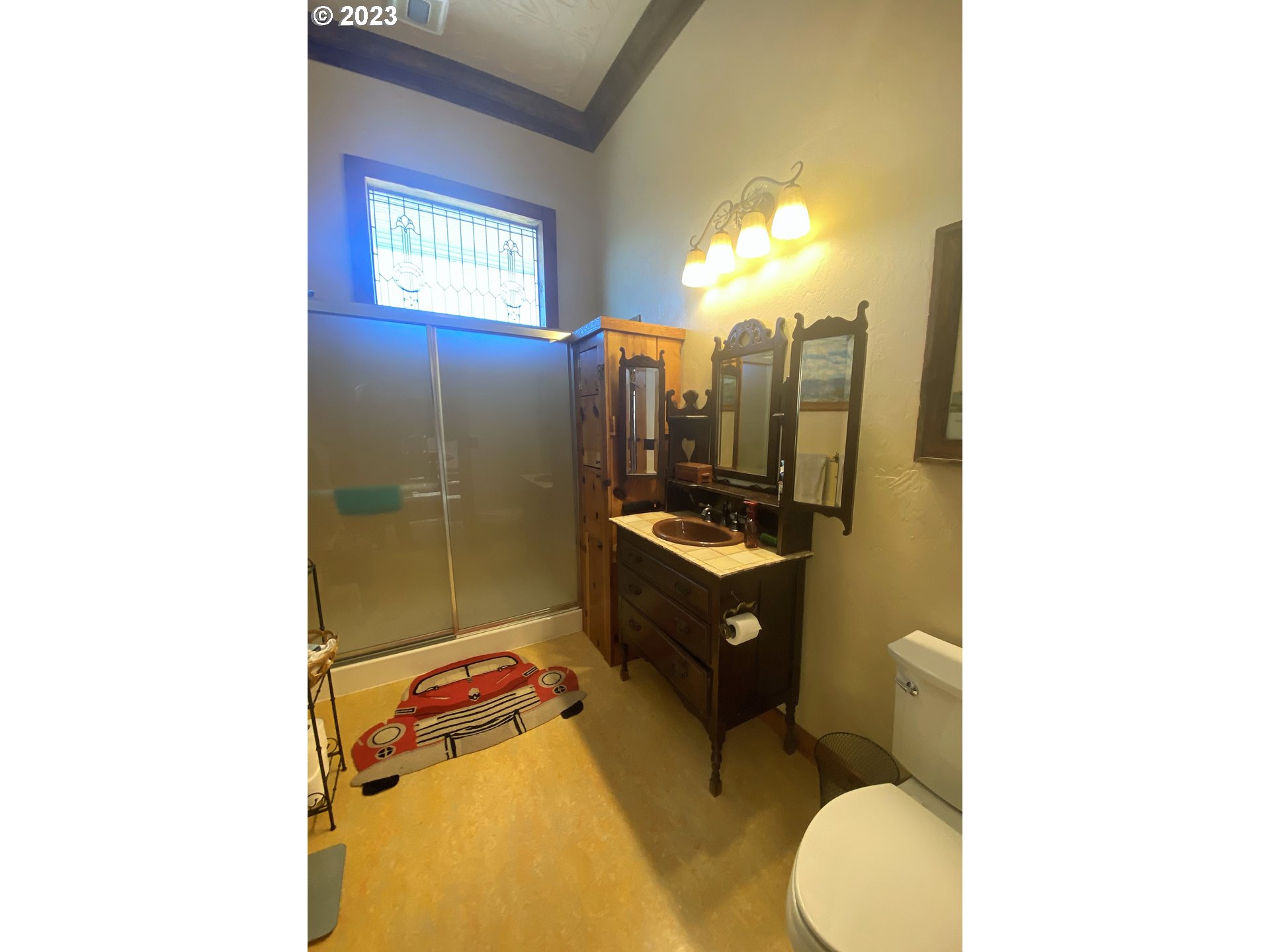 174 North 20th Street Reedsport, OR 97467 - Photo 27 of 43 a bathroom with a sink toilet mirror vanity and shower
