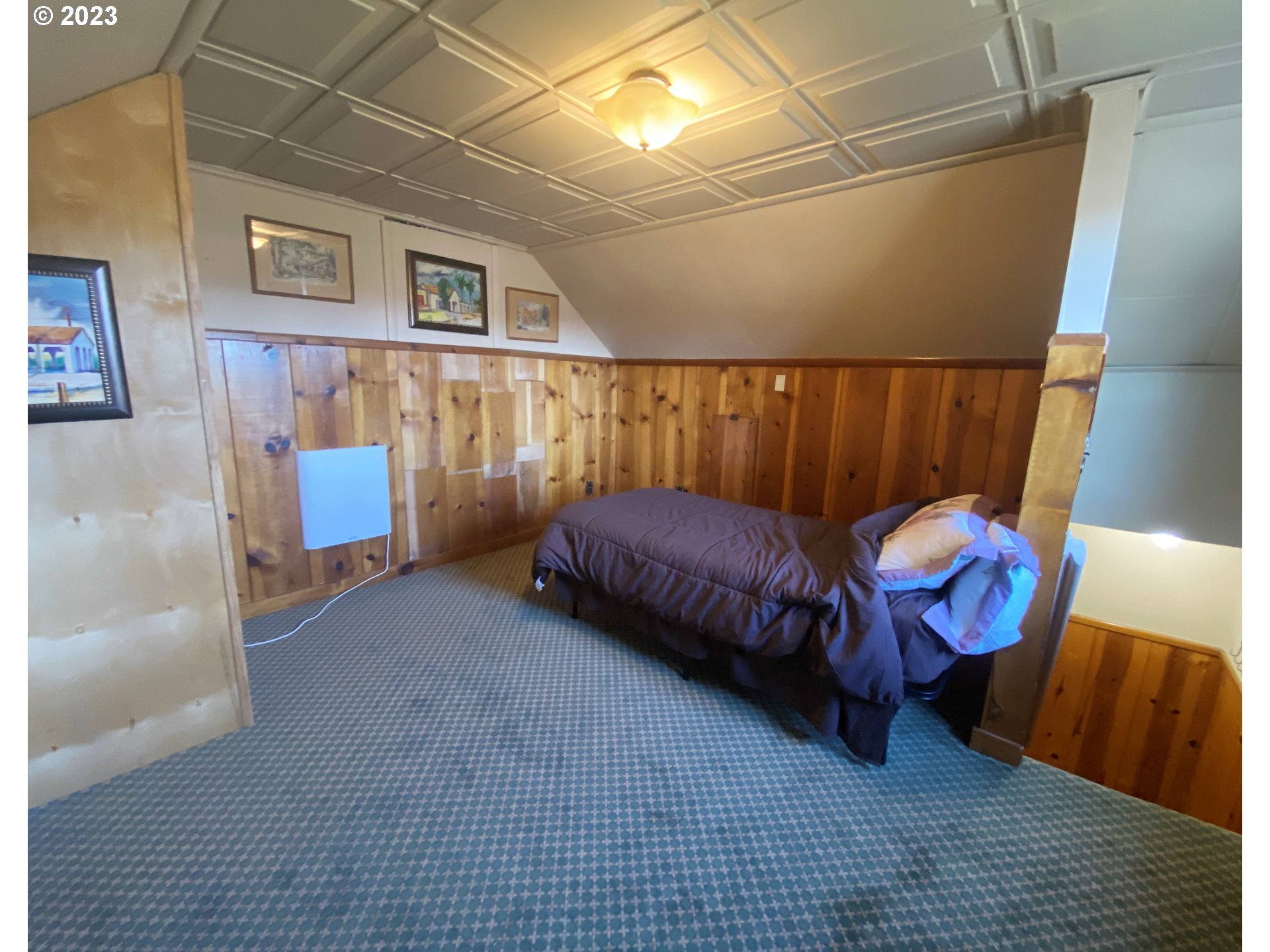 174 North 20th Street Reedsport, OR 97467 - Photo 30 of 43 a living room with a couch and a rug