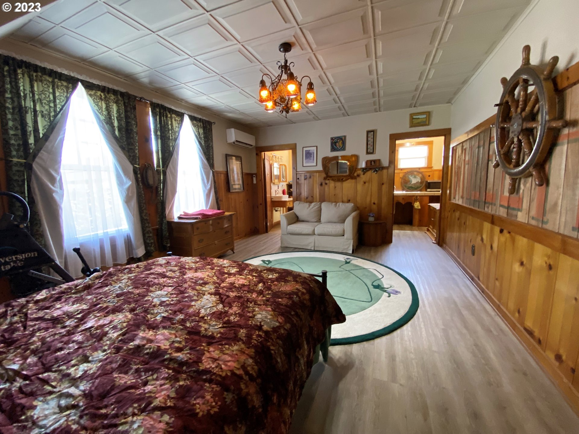 174 North 20th Street Reedsport, OR 97467 - Photo 31 of 43 a bed room with a bed and a chandelier