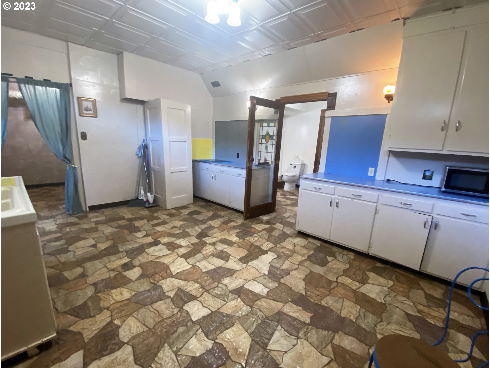 174 North 20th Street Reedsport, OR 97467 - Photo 33 of 43 a view of a kitchen with refrigerator and countertop