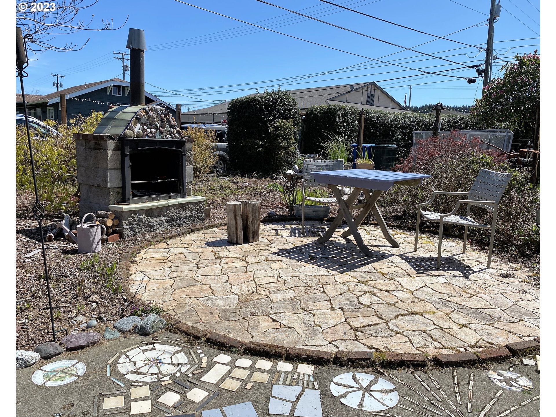 174 North 20th Street Reedsport, OR 97467 - Photo 42 of 43 a view of a patio with table and chairs potted plants