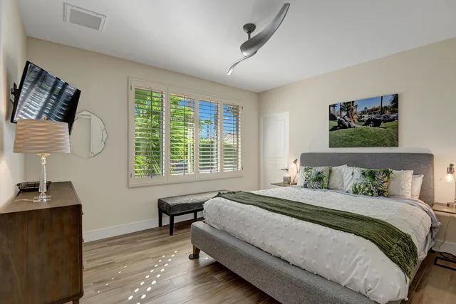 a bedroom with a bed and a desk