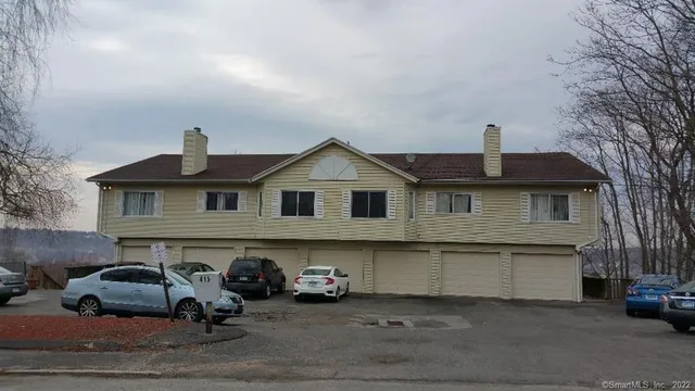 a front view of a house with parking space