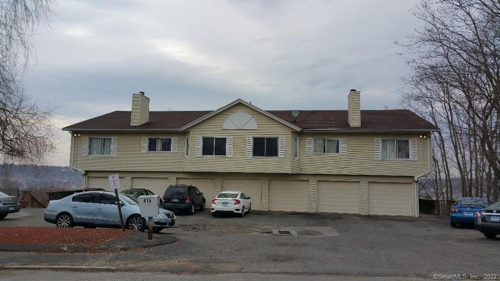 a front view of a house with parking space