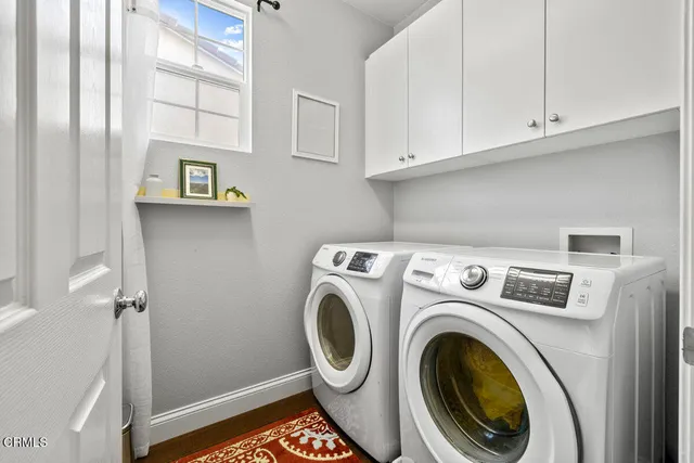 a view of storage and utility room with washer and dryer