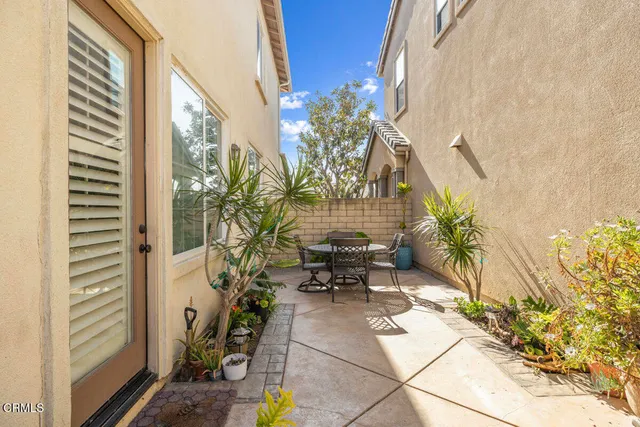 a view of balcony with two chairs and a potted plant