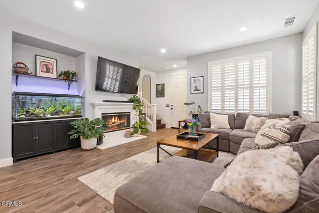 a living room with furniture fireplace and window