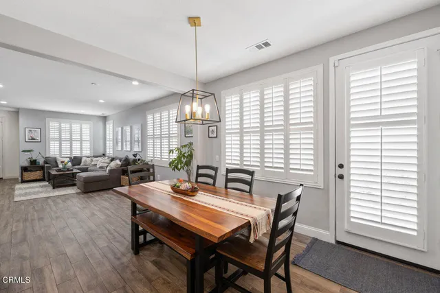 a view of a dining room with furniture wooden floor and chandelier