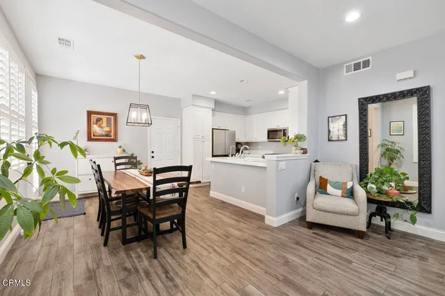 a living room with kitchen island furniture and a wooden floor