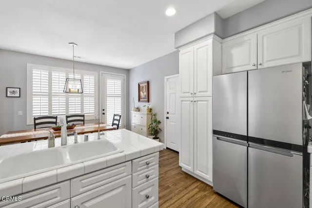 a view of a kitchen with a sink and refrigerator