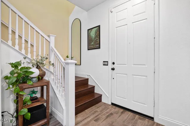 a view of staircase with wooden floor and a potted plant
