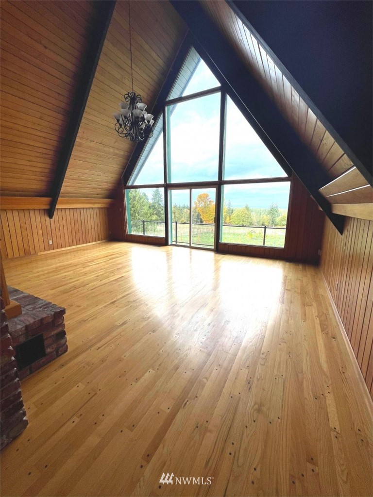 1276 Atterberry Road Sequim, WA 98382 - Photo 4 of 28 a view of an empty room with wooden floor and a window