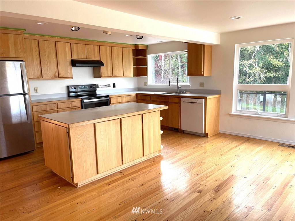 1276 Atterberry Road Sequim, WA 98382 - Photo 5 of 28 a kitchen with stainless steel appliances granite countertop a stove a sink dishwasher and a refrigerator
