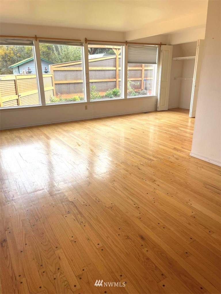 1276 Atterberry Road Sequim, WA 98382 - Photo 8 of 28 an empty room with wooden floor and windows