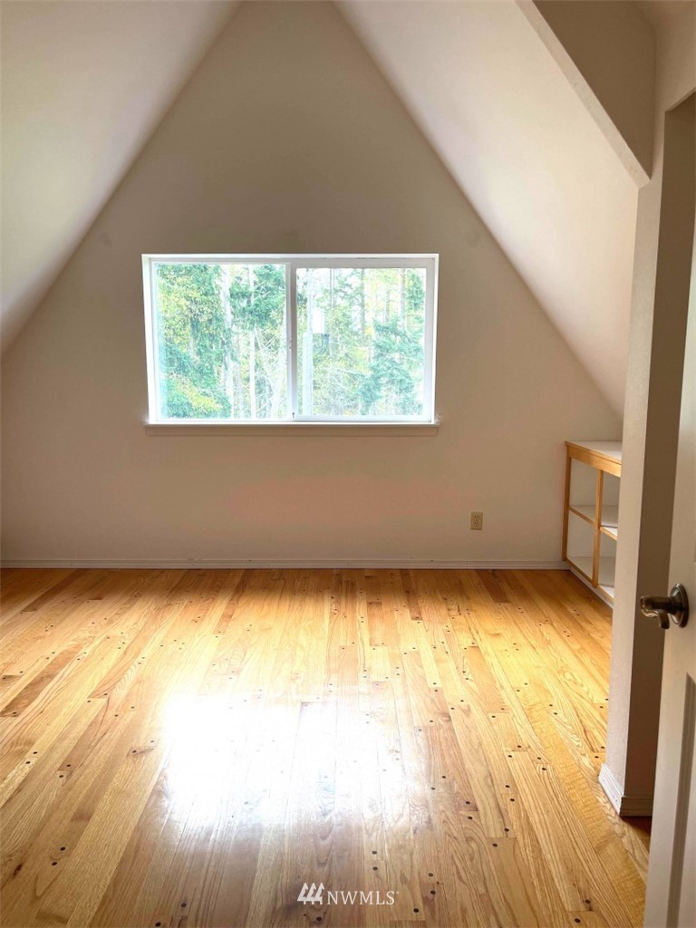 1276 Atterberry Road Sequim, WA 98382 - Photo 9 of 28 a view of an empty room with wooden floor and a window