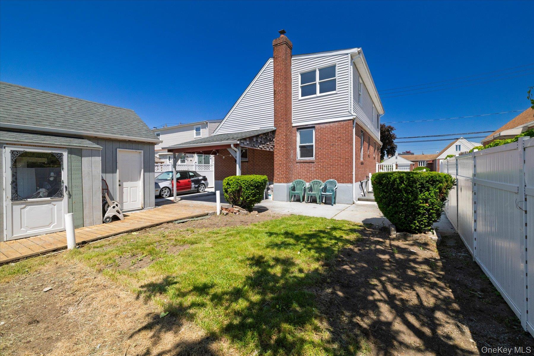 191 Raff Avenue Mineola, NY 11501 - Photo 8 of 25 a front view of a house with garden