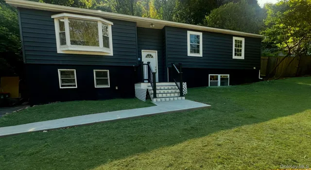 a front view of a house with a garden