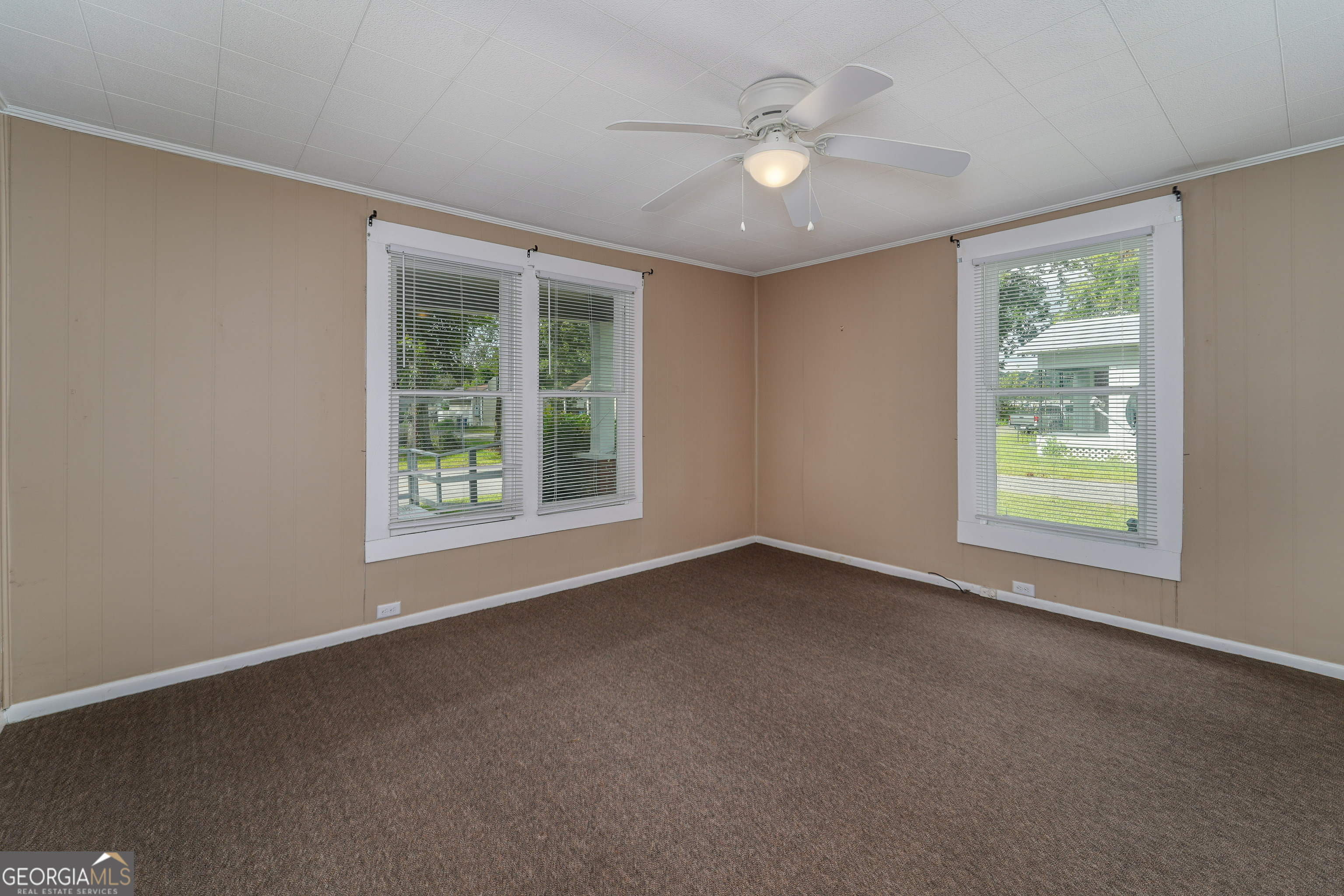 122 Hopkins Street Waycross, GA 31501 - Photo 27 of 31 an empty room with windows and fan
