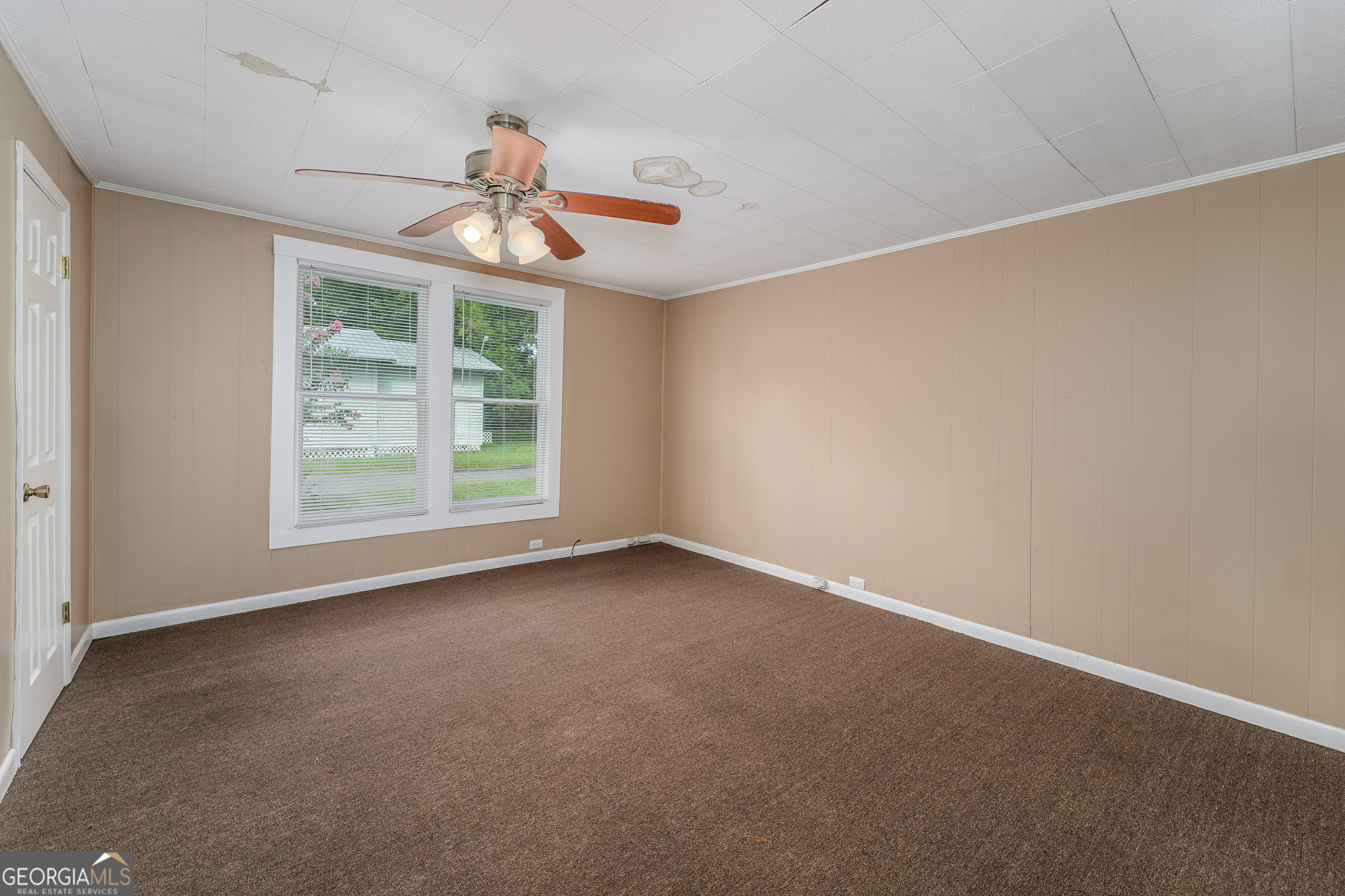 122 Hopkins Street Waycross, GA 31501 - Photo 29 of 31 an empty room with a window and a ceiling fan