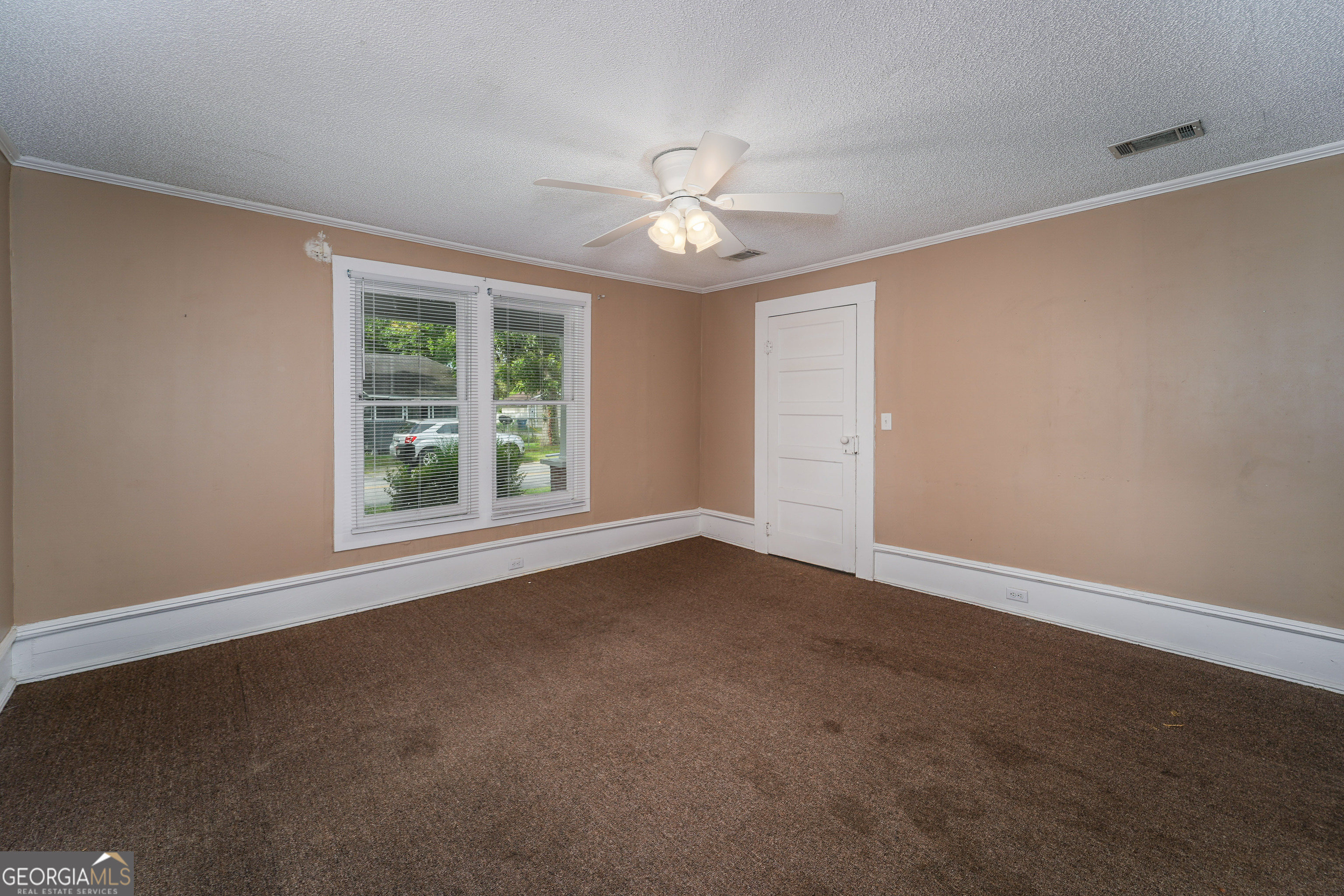 122 Hopkins Street Waycross, GA 31501 - Photo 30 of 31 en empty room with windows and ceiling fan