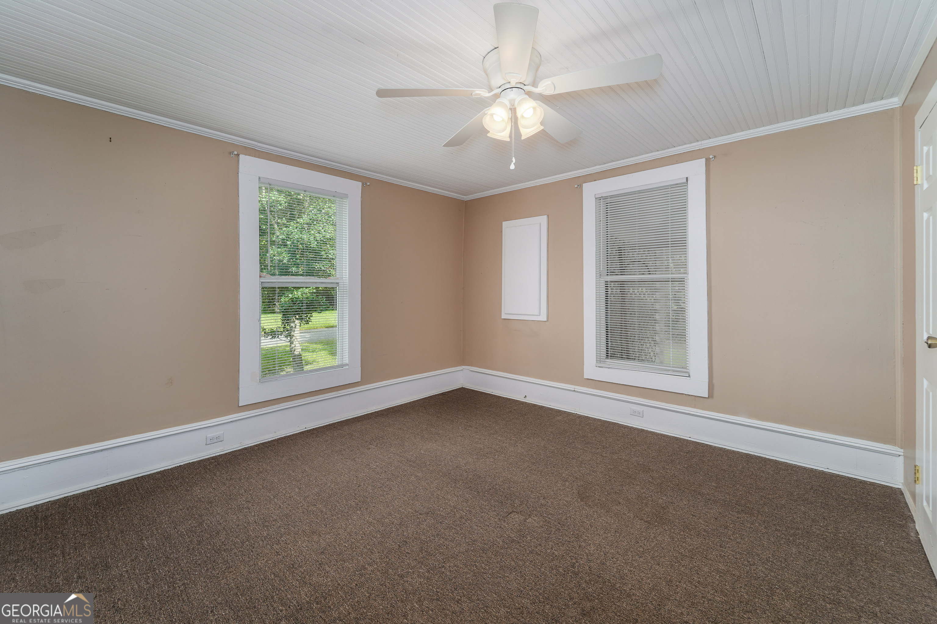 122 Hopkins Street Waycross, GA 31501 - Photo 31 of 31 an empty room with chandelier fan and windows
