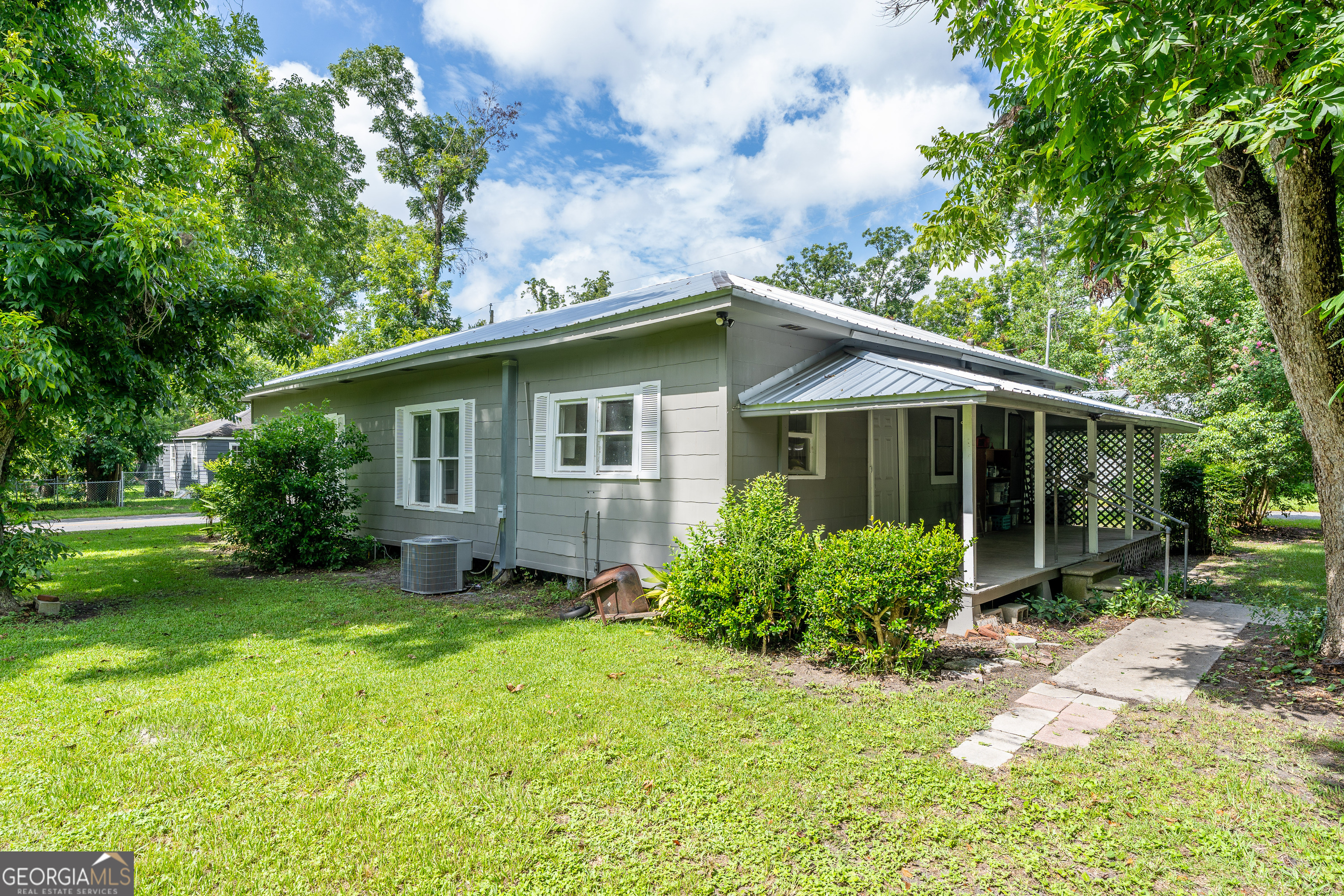 122 Hopkins Street Waycross, GA 31501 - Photo 9 of 31 a brick house with potted plants in front of it