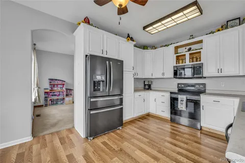 a kitchen with granite countertop a sink and cabinets