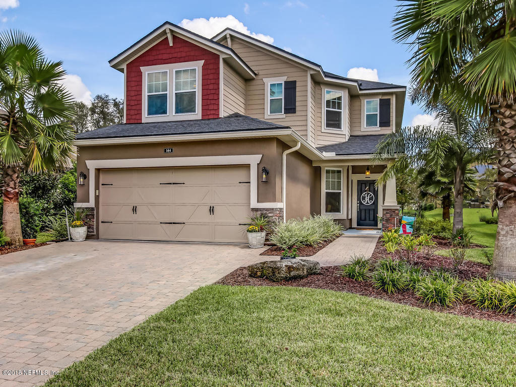 144 Maiden Terrace Ponte Vedra, FL 32081 - Photo 1 of 59 a front view of a house with a garden and plants