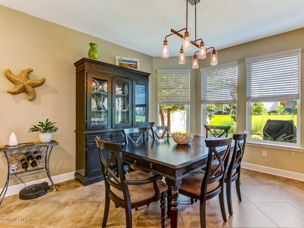 144 Maiden Terrace Ponte Vedra, FL 32081 - Photo 16 of 59 a view of a dining room with furniture a chandelier and wooden floor